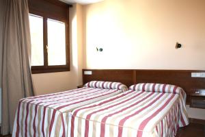 Postel nebo postele na pokoji v ubytování Apart-Hotel Selva Nevada