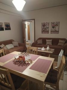 uma sala de estar com uma mesa e um sofá em House Christy em Tríkala