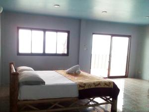 a bedroom with a bed with a laptop on it at Phangan Island in Ban Tai