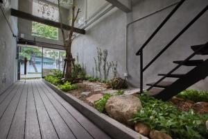 a hallway with a wooden floor and stairs in a building at Lost Inn BKK in Bangkok