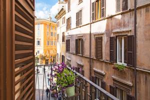 a view of a street from a balcony with flowers at Central Monserrato House with Balcony in Rome
