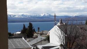 a view of a town with a lake and snowy mountains at Bariloche Apart in San Carlos de Bariloche