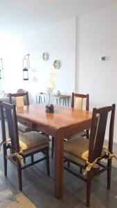 a wooden dining room table with chairs at Bariloche Apart in San Carlos de Bariloche