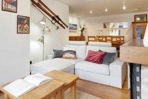 a living room with a white couch and a table at Comets by FeelFree Rentals in Vielha