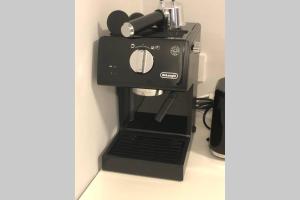 a black coffee maker sitting on top of a counter at Liverpool · CHILLINGHOUSE # 8, ICE 3 Min. NETFLIX in Siegburg
