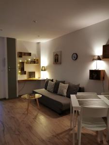 a living room with a couch and a table at La maisonnette au centre ville in Lens +5 photos