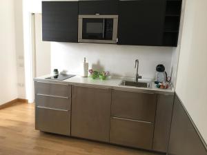 a kitchen with a sink and a microwave at H1 bzerohome in Elmas