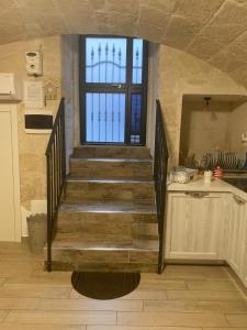 a staircase leading to a kitchen with a window at Casa Nicolo' in Monopoli