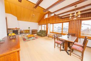 a large living room with a table and chairs at Haus Boccalino in Saas-Grund