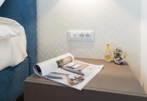 a table with a magazine and a hair dryer on it at Villa Four Brothers - Middle Floor in Podstrana
