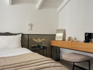 a bedroom with a bed and a desk with a mirror at Contessina Hotel in Tsilivi