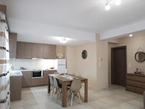 a kitchen with a table and chairs in a room at Rocks View Dream House in Kalabaka