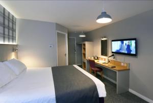 A bed or beds in a room at Waterside by Greene King Inns
