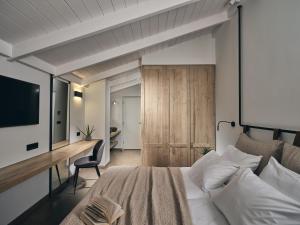a bedroom with a bed and a desk and a television at Contessina Hotel in Tsilivi