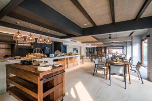 a kitchen and dining room with a table and chairs at Lullaby The Sea Hua Hin in Cha Am