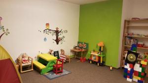 a room with green walls and toys in it at Ferienwohnung Allgäublick Regina in Bad Hindelang