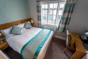 a bedroom with a large bed with a window at Queen Street Tap in Deal