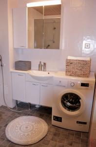 a bathroom with a washing machine and a sink at Vuokatin Lumo in Vuokatti