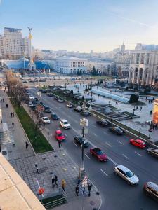 a busy city street filled with cars in a city at Amazing view of Maydan! in Kyiv