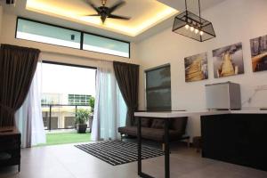 a living room with a desk and a window at Mary's Residence Ipoh in Ipoh