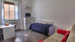a small room with a bed and a couch at Villa Laila in Lodi