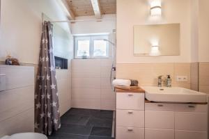 a bathroom with a sink and a shower at Ferienwohnung Riedmann in Söll