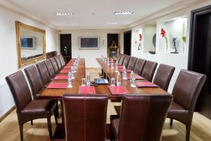 a long table in a room with brown chairs at MOXA Bucharest Boutique Hotel in Bucharest