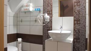 a bathroom with a sink and a mirror at Koralia Domki i Apartamenty Basen z podgrzewaną wodą in Sarbinowo +66 photos