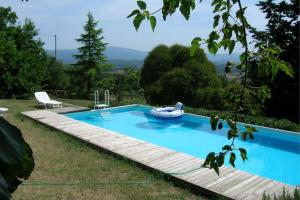 a swimming pool with a boat in a yard at CASA ROSSA in Capolona