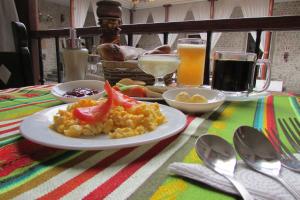 einen Tisch mit einem Teller Essen auf dem Tisch in der Unterkunft Golden Rest Ecuador in Latacunga