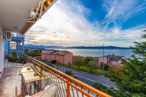 a balcony with chairs and a view of the water at Vacattio apartment 2 in Crikvenica