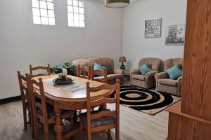 uma sala de estar com uma mesa e um sofá em VillaHouse em São Vicente