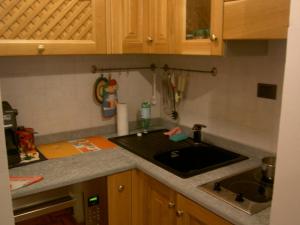 a kitchen with a sink and a counter top at Oasi Budden 1 in Breuil-Cervinia