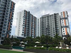 two tall apartment buildings with a pool and trees at TimurBay Residence by Onehomes in Kuantan