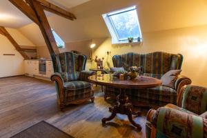 a living room with two chairs and a table at Sophienhof Achternholt in Wardenburg