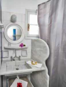a bathroom with a sink and a mirror at Aegean Village in Parikia +127 photos