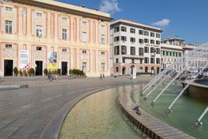 a city square with a fountain in front of a building at La Dimora del Ducale by Wonderful Italy in Genoa