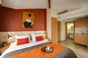 a bedroom with a large bed with an orange wall at The Fox Hotel in Istanbul