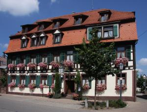 a large building with flowers in front of it at Hotel Ochsen Post in Tiefenbronn