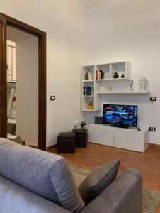 a living room with a couch and a flat screen tv at Casa vacanze Ai Corrieri in Palermo