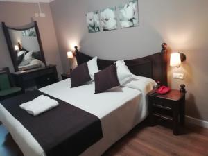 Hotel Montearoma tesisinde bir odada yatak veya yataklar