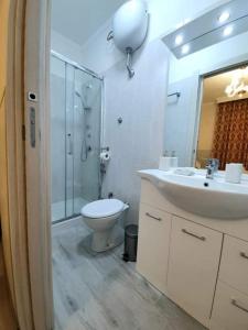 a bathroom with a toilet and a sink and a shower at Oscar suite home in Rome