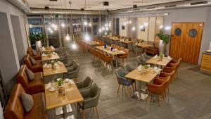 a restaurant with tables and chairs in a room at cantera by Wiegand in Wunstorf