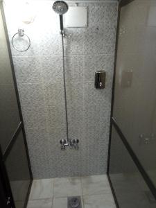 a shower with a glass door in a bathroom at Happy Night Hostel in Wadi Musa