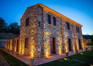 a large stone building with lights on it at Casena Mongerrati in Collesano