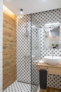 a bathroom with a sink and a shower at Joy Apartment Burgas center private parking in Burgas
