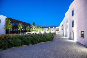 an empty alley between two buildings with plants at Pestana Cidadela Cascais - Pousada & Art District in Cascais