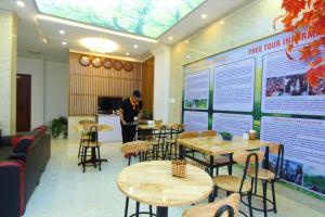 a person standing in a restaurant with tables and chairs at Himalaya Sapa Hotel in Sapa