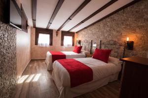 A bed or beds in a room at Palacito de la Rubia