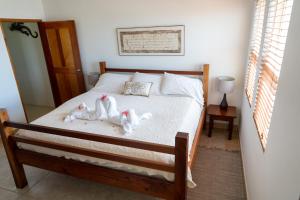 
a bed in a room with a wooden bed frame at Caye Reef Condos in Caye Caulker

